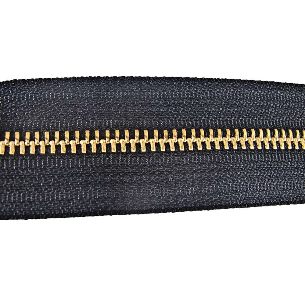 129-135301.SLC.jpg YKK #5 Zipper Tape - Black/Brass Yard Image