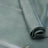 A close-up of a rolled piece of smooth leather in a muted sage green color, laid out on a matching background.