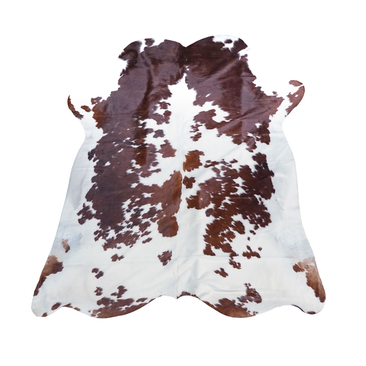 Brown and white cowhide rug with natural mottled spots, displayed flat against a solid white background.
