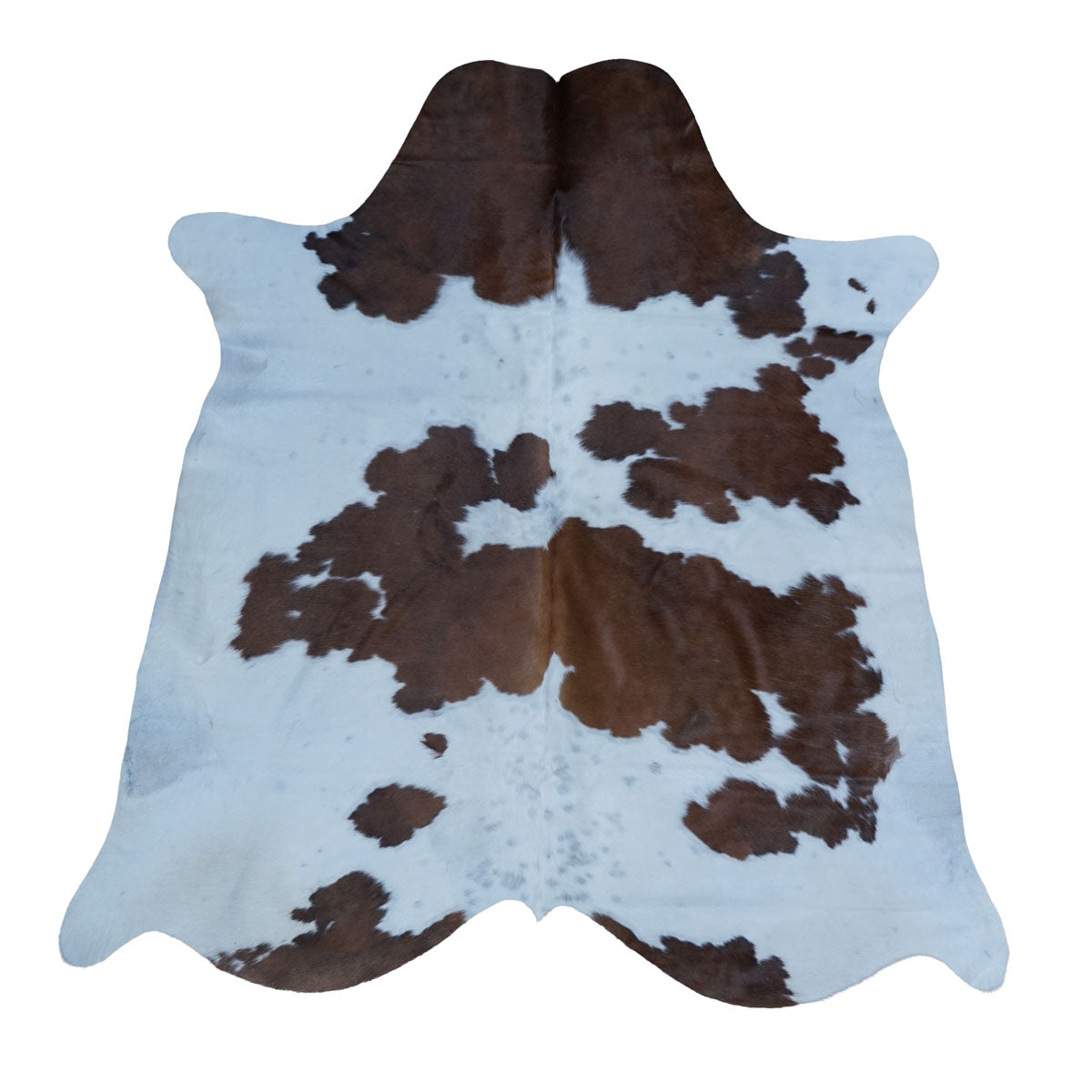 Brown and white cowhide rug with a natural spotted pattern, displayed flat against a solid white background.